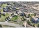 Aerial view of a luxurious home surrounded by mature trees and landscaping in a private community at 1289 Diamond Ridge Cir, Castle Rock, CO 80108