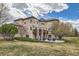 Expansive backyard features a spacious deck, patio area, and mature landscaping at 1289 Diamond Ridge Cir, Castle Rock, CO 80108