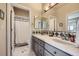Well-lit bathroom features double sinks, a large mirror, and a separate shower/toilet room at 1289 Diamond Ridge Cir, Castle Rock, CO 80108