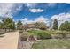 Beautiful home featuring lush landscaping, mature trees, and a circular driveway at 1289 Diamond Ridge Cir, Castle Rock, CO 80108