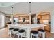 Bright kitchen features an island with seating, pendant lighting, stainless steel appliances, and wooden cabinetry at 1289 Diamond Ridge Cir, Castle Rock, CO 80108