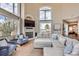 Cozy living room featuring vaulted ceilings, large windows, and a comfortable seating area at 1289 Diamond Ridge Cir, Castle Rock, CO 80108