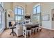 Elegant living room boasts high ceilings, large windows, a cozy fireplace, and stylish decor at 1289 Diamond Ridge Cir, Castle Rock, CO 80108
