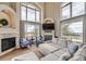 Spacious living room featuring a fireplace, vaulted ceilings, and large windows for natural light at 1289 Diamond Ridge Cir, Castle Rock, CO 80108