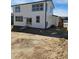 New construction home featuring a white exterior, multiple windows and a sliding glass door that provides backyard access at 6071 Caribou Dr, Brighton, CO 80601