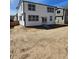 Spacious backyard with a sliding glass door leading to the house, offering great outdoor potential at 6071 Caribou Dr, Brighton, CO 80601