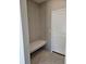 Mudroom featuring a built-in bench and a white door, creating a clean and functional space at 6071 Caribou Dr, Brighton, CO 80601
