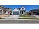 Beautiful two-story home with white siding, a gray garage door, and a well-maintained lawn at 6071 Caribou Dr, Brighton, CO 80601