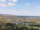 Scenic aerial view of the neighborhood featuring two lakes, a golf course and mountain vistas at 6170 Falcon Ln, Morrison, CO 80465