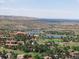 Beautiful aerial view features two lakes, a golf course, upscale homes, and rolling hills at 6170 Falcon Ln, Morrison, CO 80465