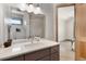 Modern bathroom featuring sleek vanity with stone countertop and tiled shower at 6170 Falcon Ln, Morrison, CO 80465