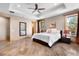 Spacious bedroom with decorative tray ceiling, large windows, and a cozy atmosphere at 6170 Falcon Ln, Morrison, CO 80465