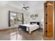 Bright bedroom with a ceiling fan, large window, and modern decor at 6170 Falcon Ln, Morrison, CO 80465