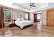 Bright bedroom with tray ceiling, large windows, and access to a private balcony at 6170 Falcon Ln, Morrison, CO 80465