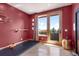 Red accent room with natural light, exercise mat, and balcony access at 6170 Falcon Ln, Morrison, CO 80465