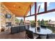 Covered deck with a fireplace, seating area, and mountain views at 6170 Falcon Ln, Morrison, CO 80465