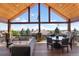 Spacious covered deck with outdoor seating and panoramic views at 6170 Falcon Ln, Morrison, CO 80465