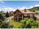 Stunning two-story home with stone accents, balconies, and beautiful landscaping at 6170 Falcon Ln, Morrison, CO 80465
