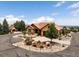Stunning exterior elevation with professional landscaping showcasing the beautiful circular drive leading up to the home at 6170 Falcon Ln, Morrison, CO 80465