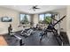 Bright home gym featuring modern fitness equipment, rubber flooring, and scenic views from large windows at 6170 Falcon Ln, Morrison, CO 80465