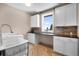 Bright laundry room with sink, washer, dryer and abundant counterspace at 6170 Falcon Ln, Morrison, CO 80465