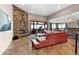 Inviting living room features a stacked stone fireplace and views of the mountains at 6170 Falcon Ln, Morrison, CO 80465