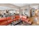 Spacious living room features a modern sectional sofa and an open-concept layout connecting it seamlessly to the gourmet kitchen at 6170 Falcon Ln, Morrison, CO 80465