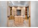 Bright office featuring custom built-ins, a large center island, and beautiful hardwood flooring at 6170 Falcon Ln, Morrison, CO 80465