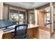 Office with large windows offering views, paired with wood floors and accents at 6170 Falcon Ln, Morrison, CO 80465