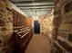 Charming wine cellar with extensive bottle storage, stone walls, and unique lighting at 6170 Falcon Ln, Morrison, CO 80465