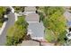 Aerial view of a home with a well-maintained roof, surrounded by mature trees and established landscaping at 16225 Peregrine Dr, Parker, CO 80134