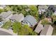 Aerial view of a home with a well-maintained roof, surrounded by mature trees and established landscaping at 16225 Peregrine Dr, Parker, CO 80134