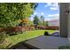 Lush backyard featuring a concrete patio and a beautifully landscaped garden with mature trees at 16225 Peregrine Dr, Parker, CO 80134
