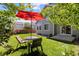 Inviting backyard with an umbrella-covered table and chairs for outdoor enjoyment at 16225 Peregrine Dr, Parker, CO 80134