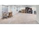 Spacious finished basement area with neutral carpet, table, and shelving for flexible living and storage at 16225 Peregrine Dr, Parker, CO 80134