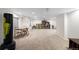 Spacious finished basement area with neutral carpet, table, shelving, and a Golds Gym heavy bag at 16225 Peregrine Dr, Parker, CO 80134