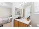 Bathroom featuring a vanity with sink, mirror, and an open doorway to another room at 16225 Peregrine Dr, Parker, CO 80134