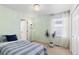 Airy bedroom with a large window, potted plants, and a comfortable looking bed at 16225 Peregrine Dr, Parker, CO 80134