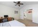 Bright bedroom featuring a ceiling fan, desk, and doorway leading to another room at 16225 Peregrine Dr, Parker, CO 80134