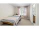 Comfortable bedroom featuring a bed and a window with pink curtains at 16225 Peregrine Dr, Parker, CO 80134
