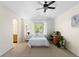 Bright main bedroom with carpet, a ceiling fan, and an ensuite bathroom at 16225 Peregrine Dr, Parker, CO 80134