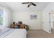 Bright bedroom with carpet, a ceiling fan, desk space, and a large window at 16225 Peregrine Dr, Parker, CO 80134