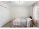 Simple bedroom featuring a bed, window, and closet with double doors at 16225 Peregrine Dr, Parker, CO 80134