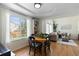 Bright dining area with hardwood floors, a round table, and views of the fenced backyard at 16225 Peregrine Dr, Parker, CO 80134