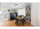 Bright dining area featuring hardwood floors, a round table, and a piano at 16225 Peregrine Dr, Parker, CO 80134