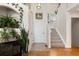 Welcoming entryway with hardwood floors, a staircase, fireplace and arched niche with indoor plants at 16225 Peregrine Dr, Parker, CO 80134