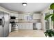 Functional kitchen with white cabinets, stainless steel appliances, and tile flooring at 16225 Peregrine Dr, Parker, CO 80134