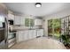 Functional kitchen with white cabinets, stainless steel appliances, and a sliding glass door at 16225 Peregrine Dr, Parker, CO 80134