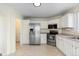 Functional kitchen with white cabinets, stainless steel appliances, and tile flooring at 16225 Peregrine Dr, Parker, CO 80134