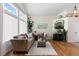 Inviting living room featuring hardwood floors, a cozy fireplace, and lots of natural light at 16225 Peregrine Dr, Parker, CO 80134